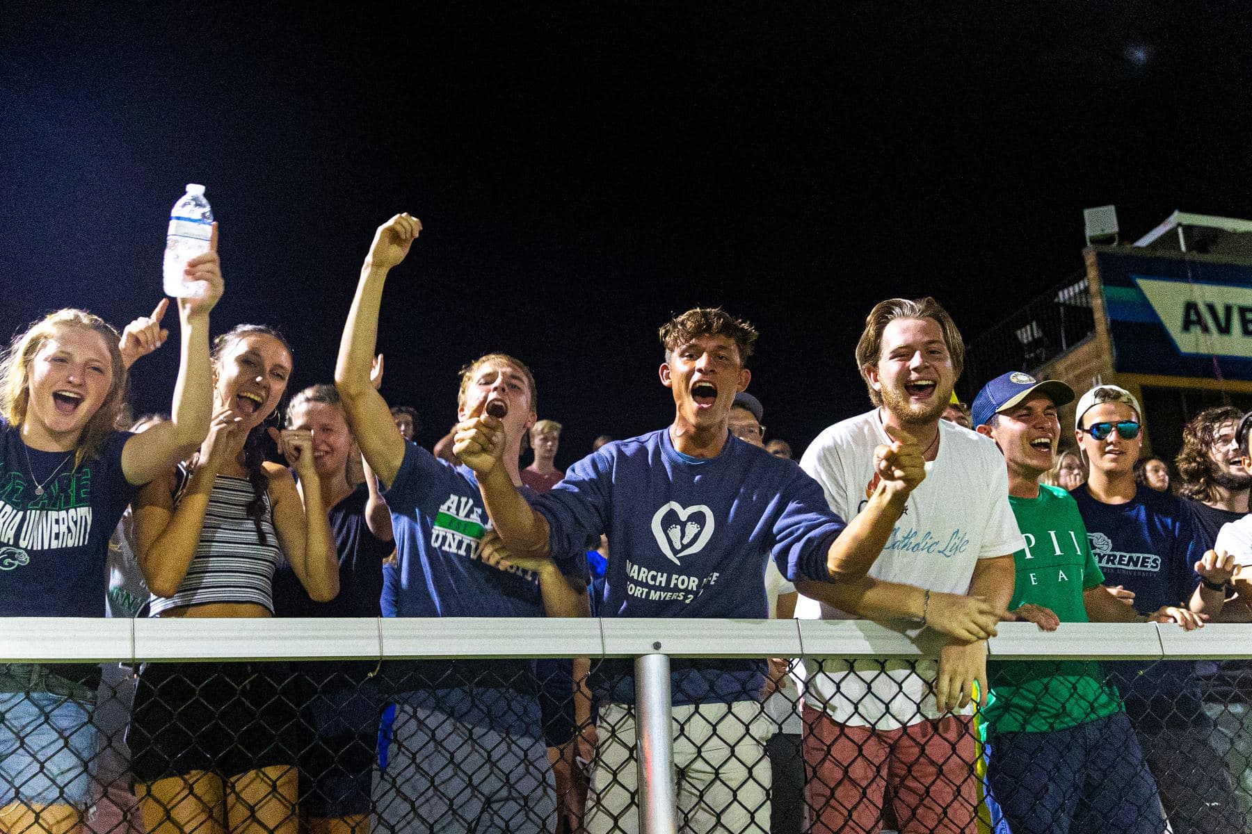 Alumni cheering at an Ave Maria University Homecoming football game
