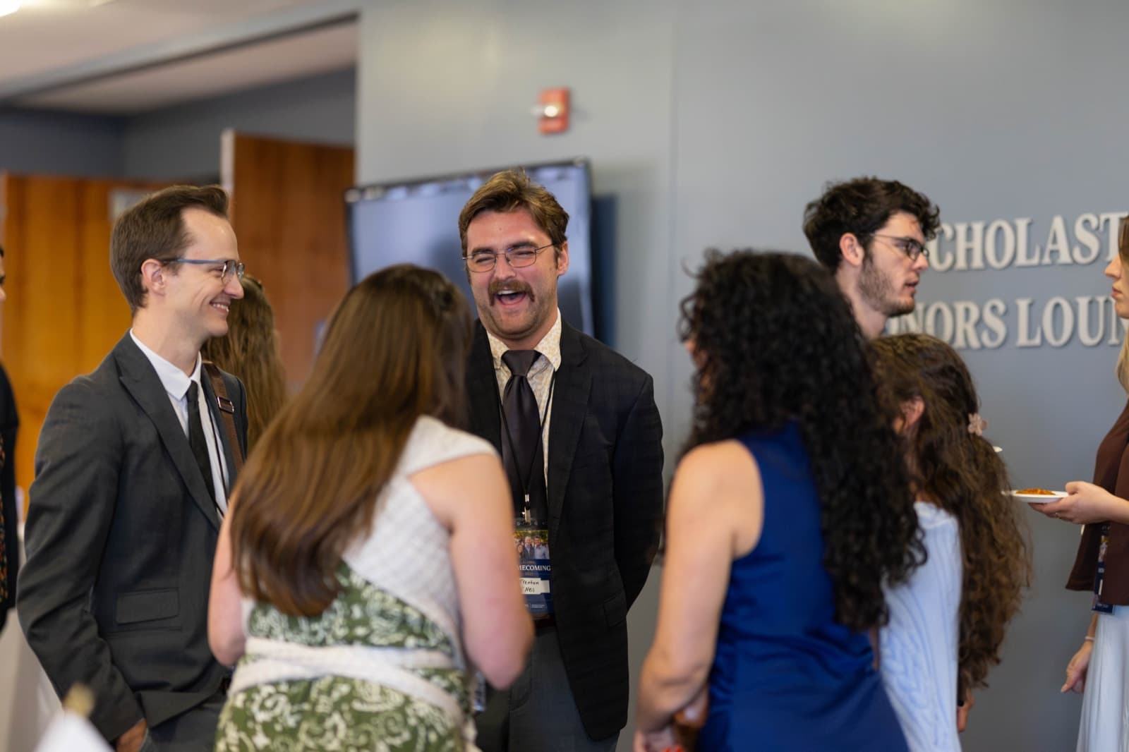 Alumni welcoming fellow graduates at the Alumni Homecoming reception