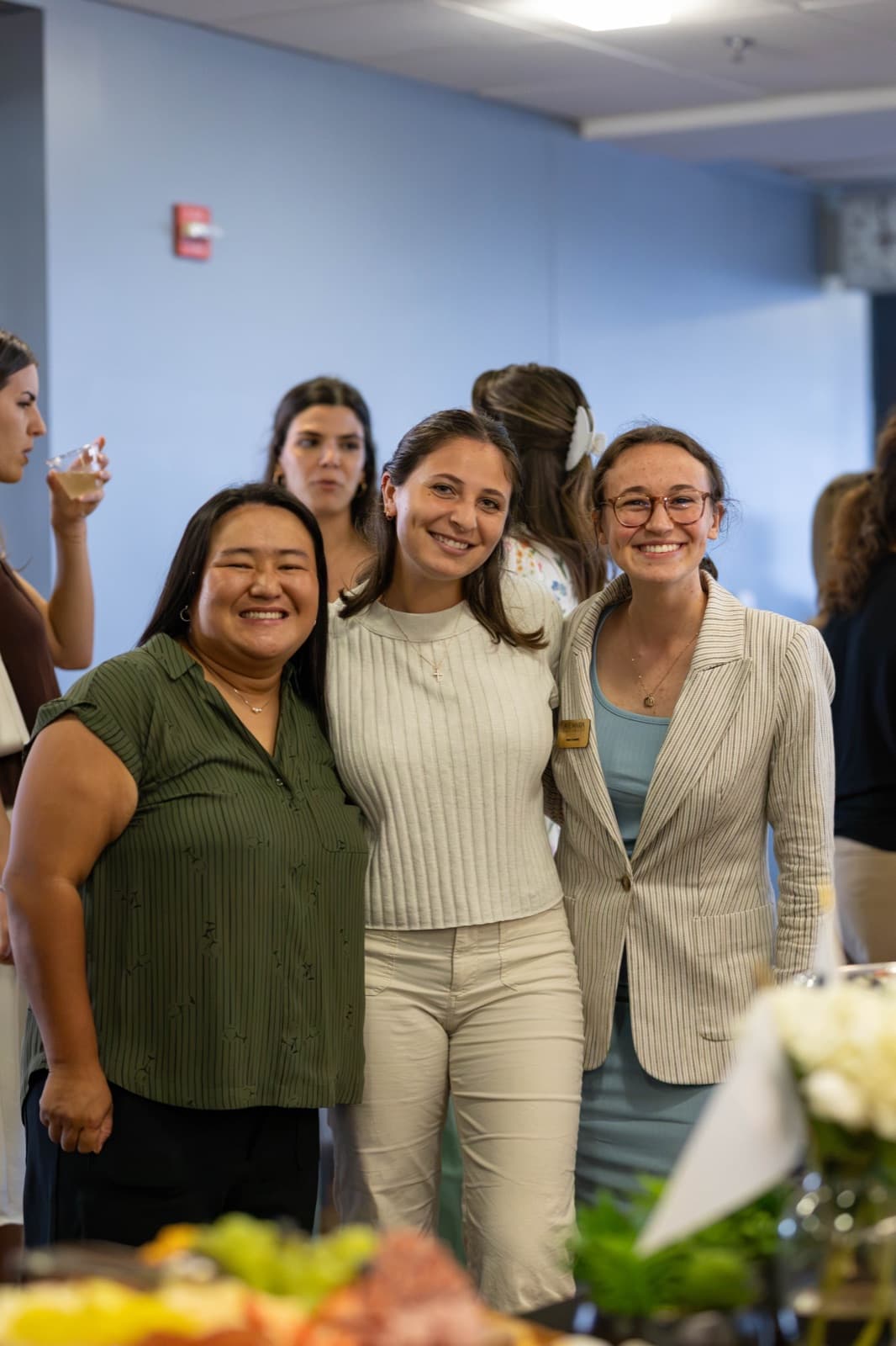 Alumni sharing laughter during the evening Homecoming reception