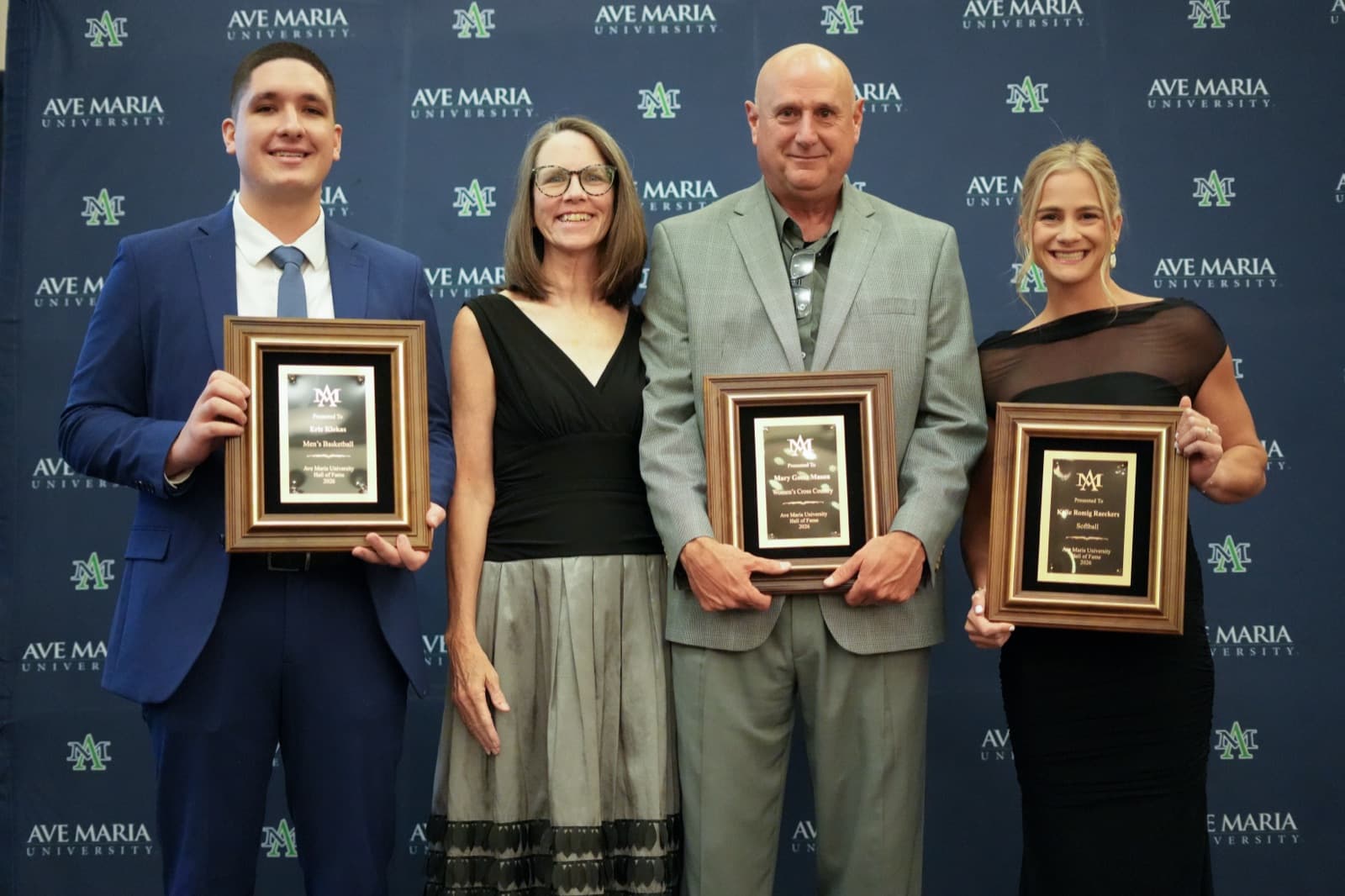 Hall of Fame honoree celebrating with family and athletics leadership