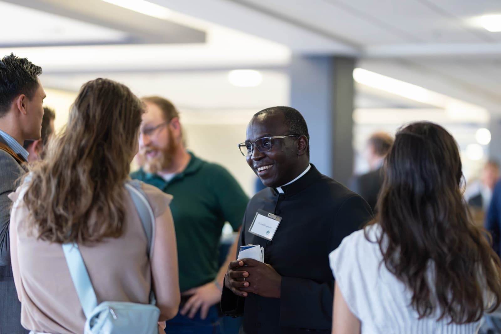 Group of Ave Maria University alumni smiling at the Homecoming reception