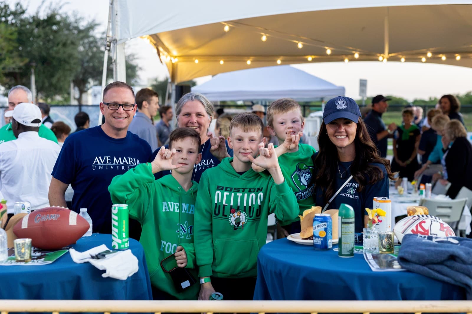Friends posing together at the Homecoming football tailgate
