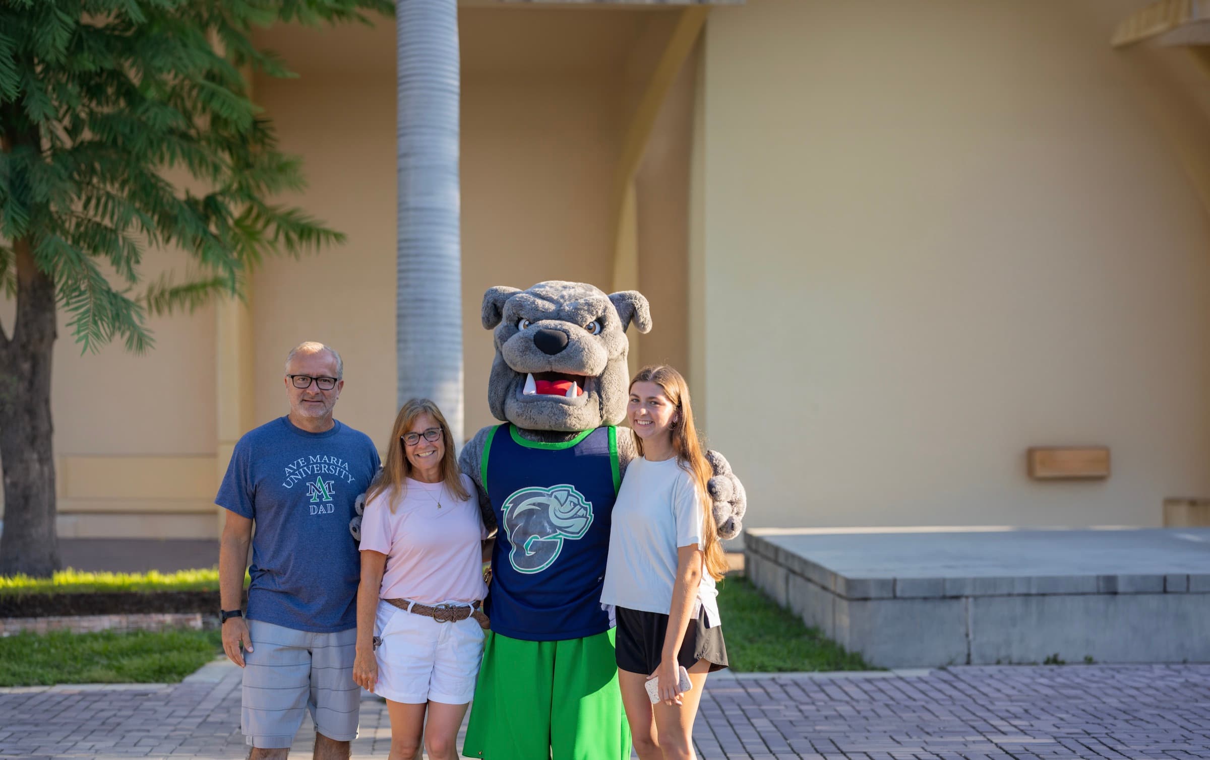 A family with the bulldog mascot on campus during Parents & Family Weekend