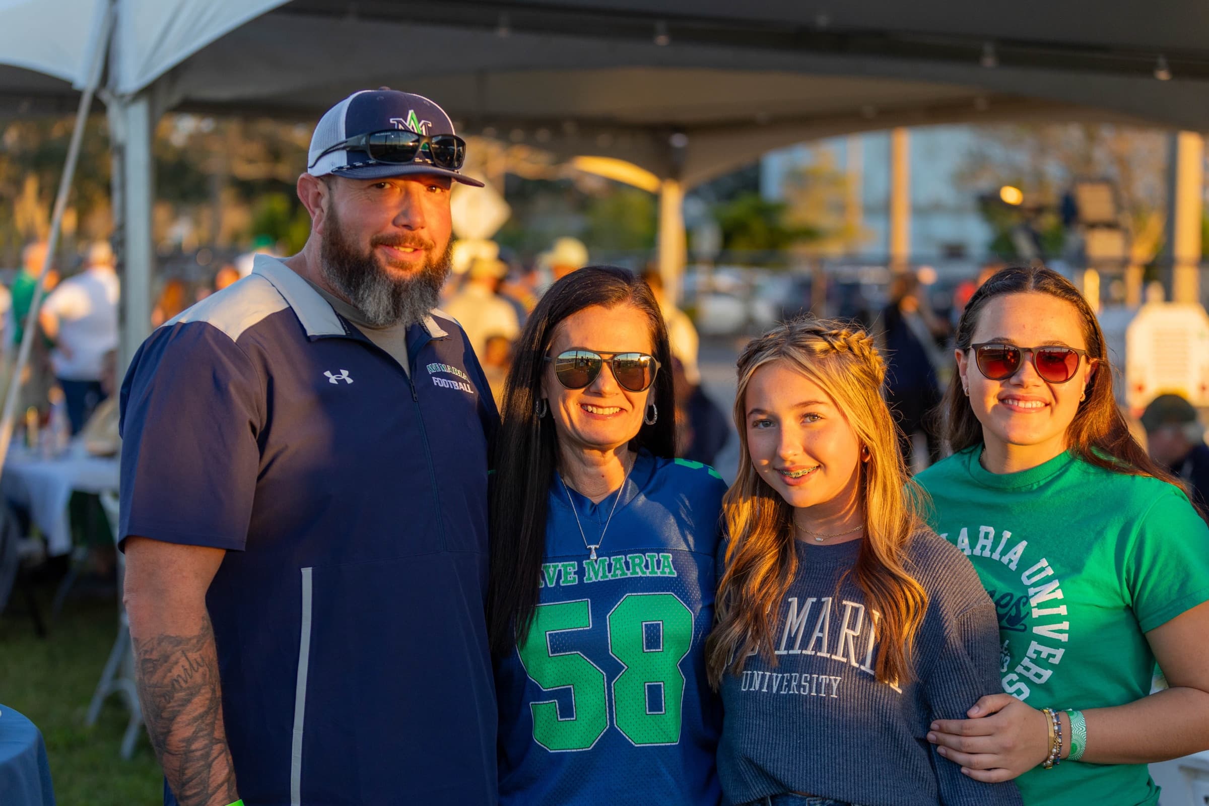 A family together at a campus tailgate event