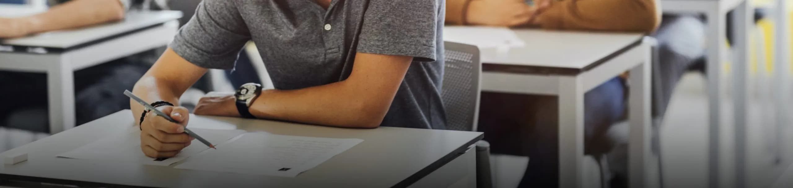 Student writing during a final exam at Ave Maria University